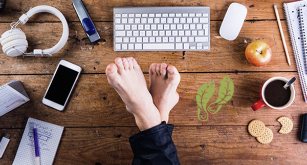 Blog bare feet on desk with keyboard